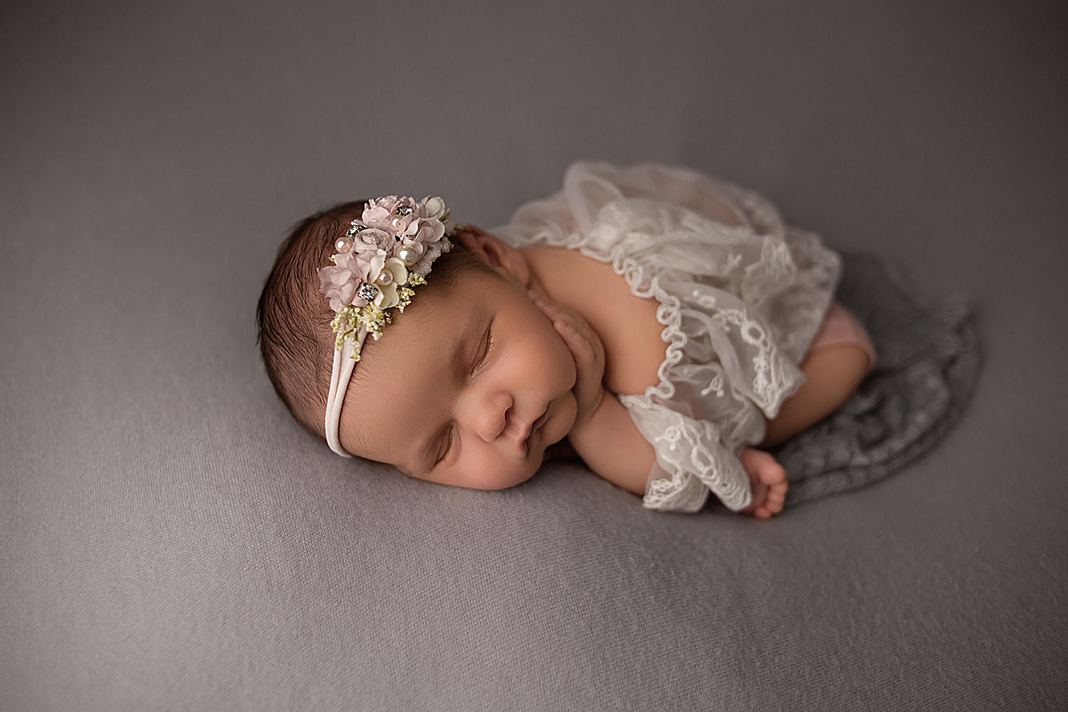 newborn photoshoot of baby on gray fabric in pembroke pines, fl