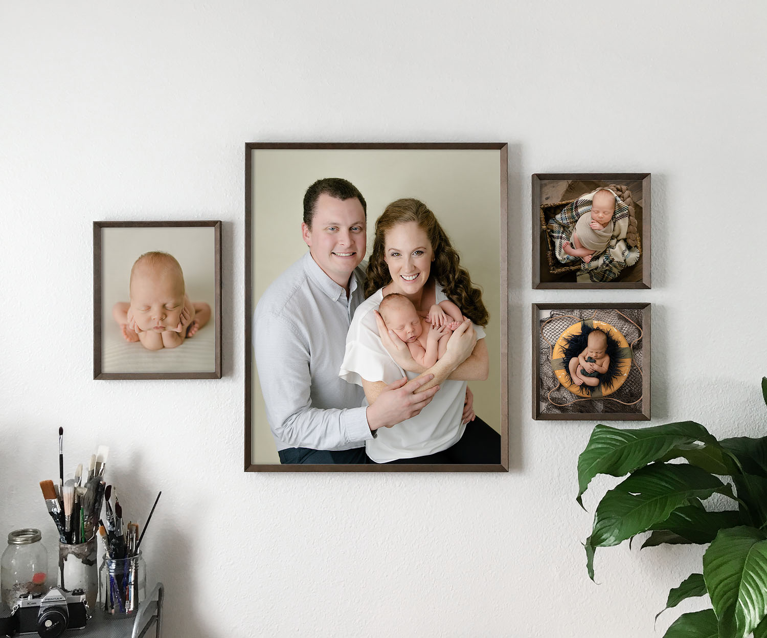 wall gallery of framed portraits of family with newborn in pembroke pines, fl