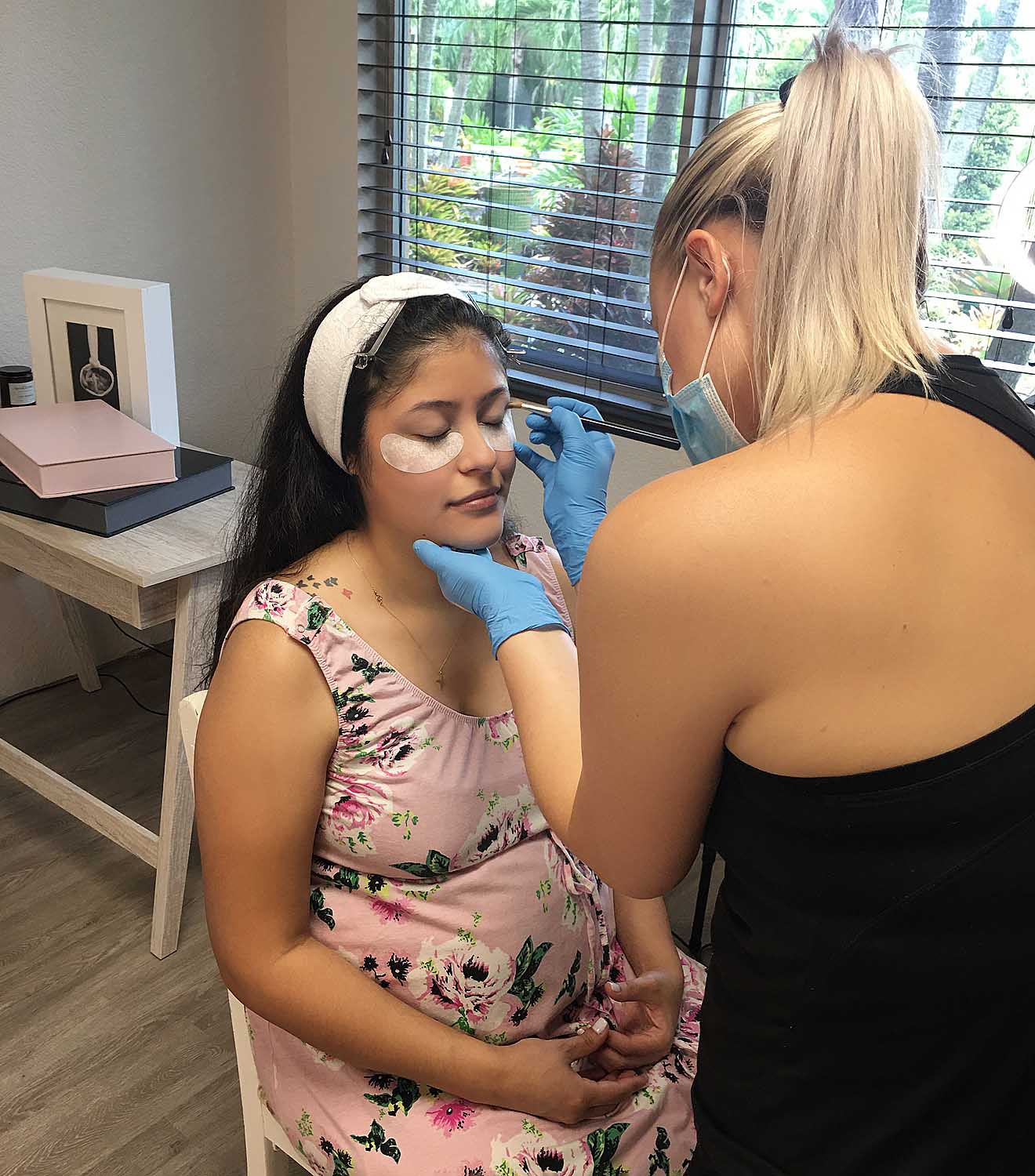 pregnant woman having her makeup done for her maternity photos in south florida