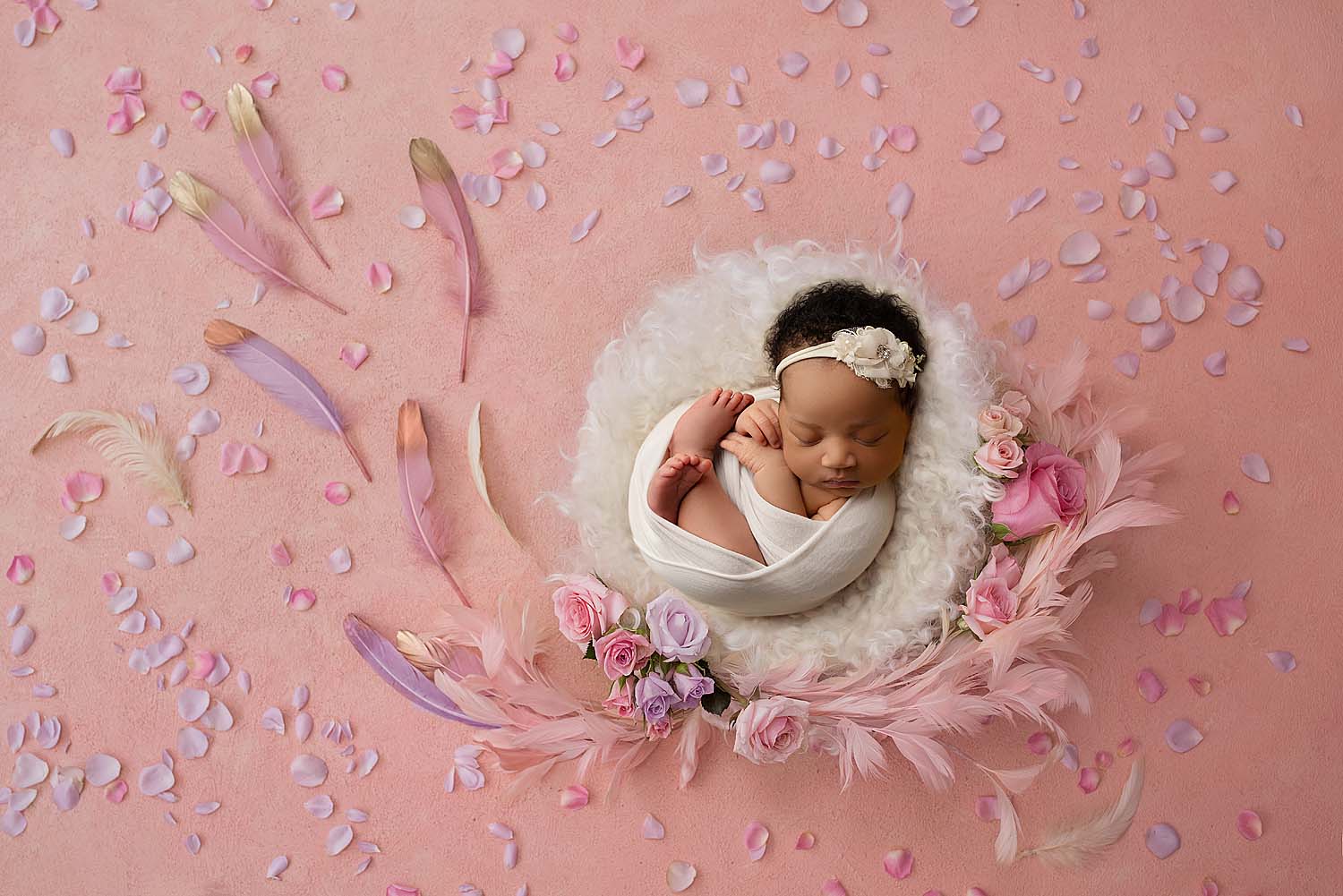 newborn baby girl photographed on flower prop in coral springs, fl