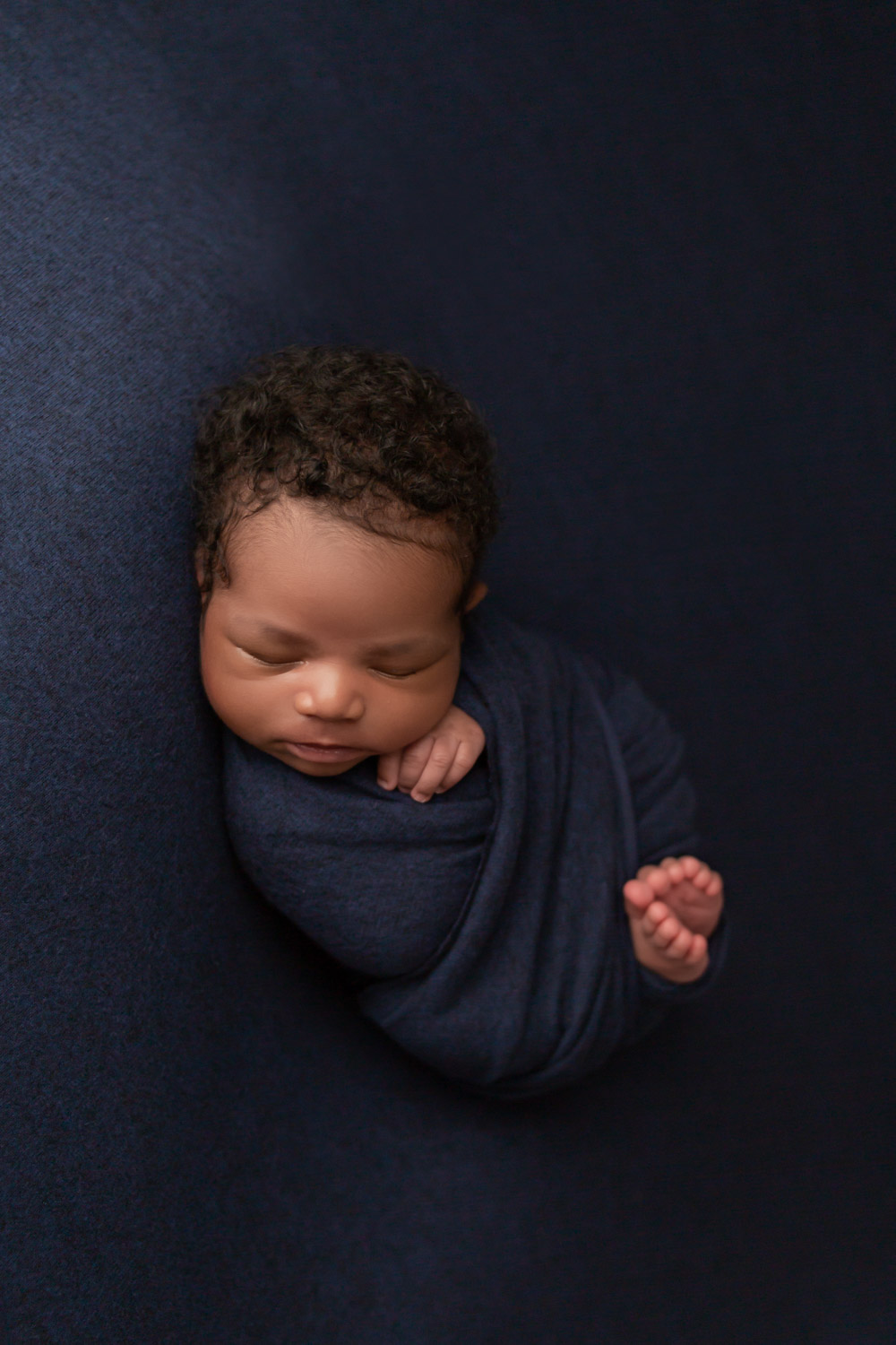 baby boy photographed in a blue wrap with toes peeking out in pembroke pines, fl