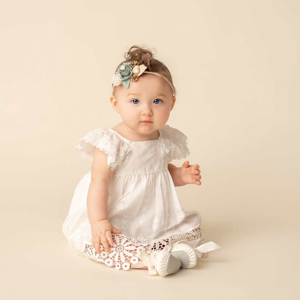 baby girl wearing white dress sitting up in weston, fl