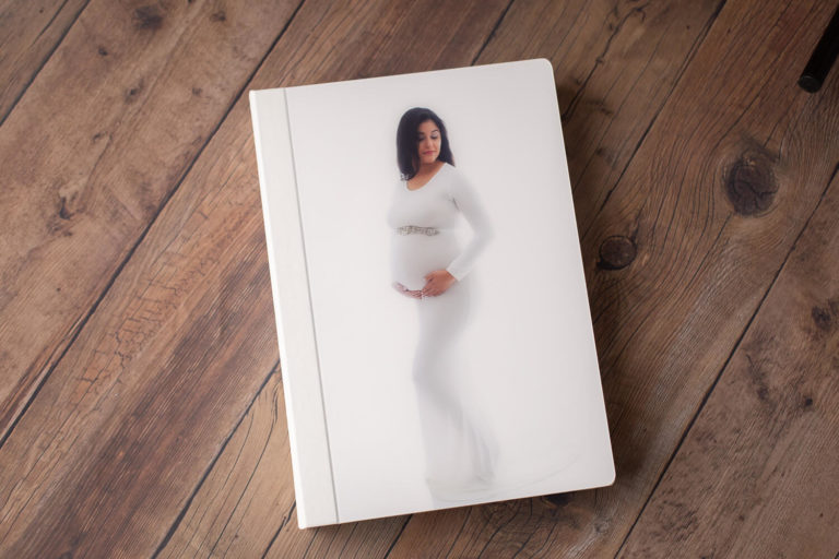 folio box with maternity and newborn photos
