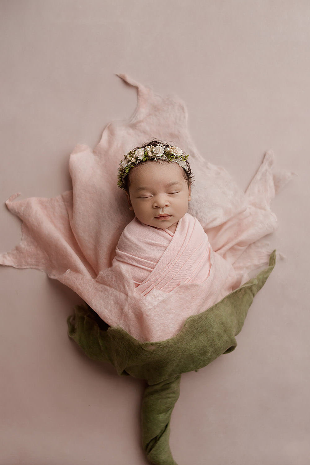 newborn baby wrapped in a flower copy