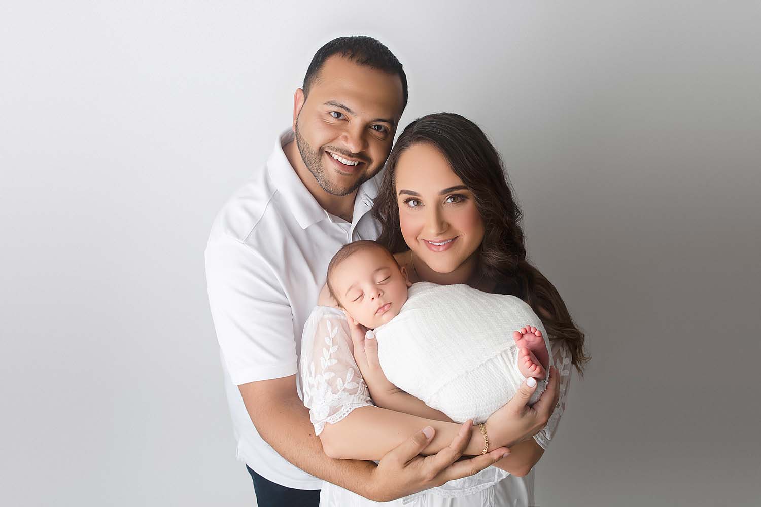 Family posed with baby for newborn session in miami, FL