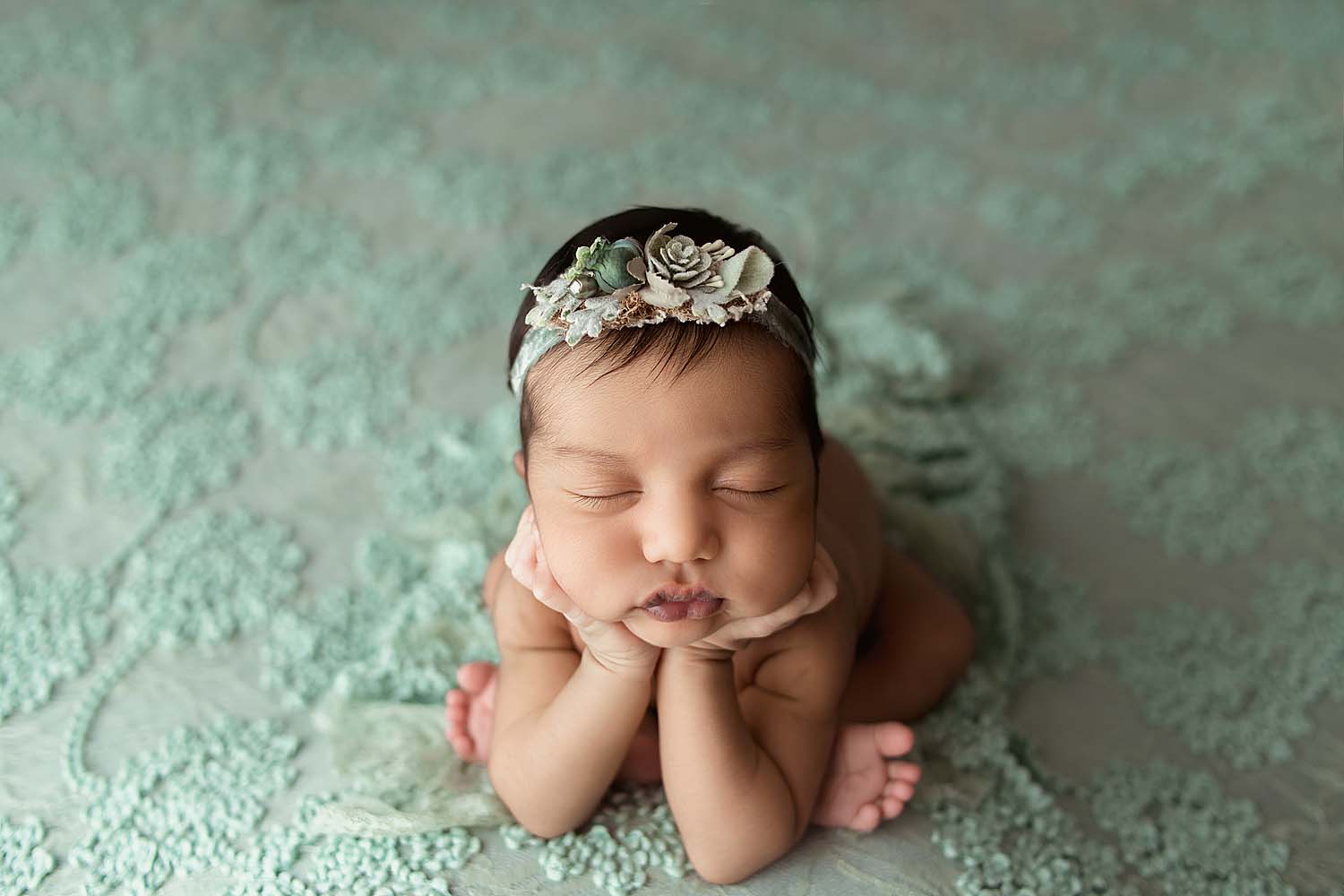 baby posed in froggy pose for newborn photos in coral springs, FL