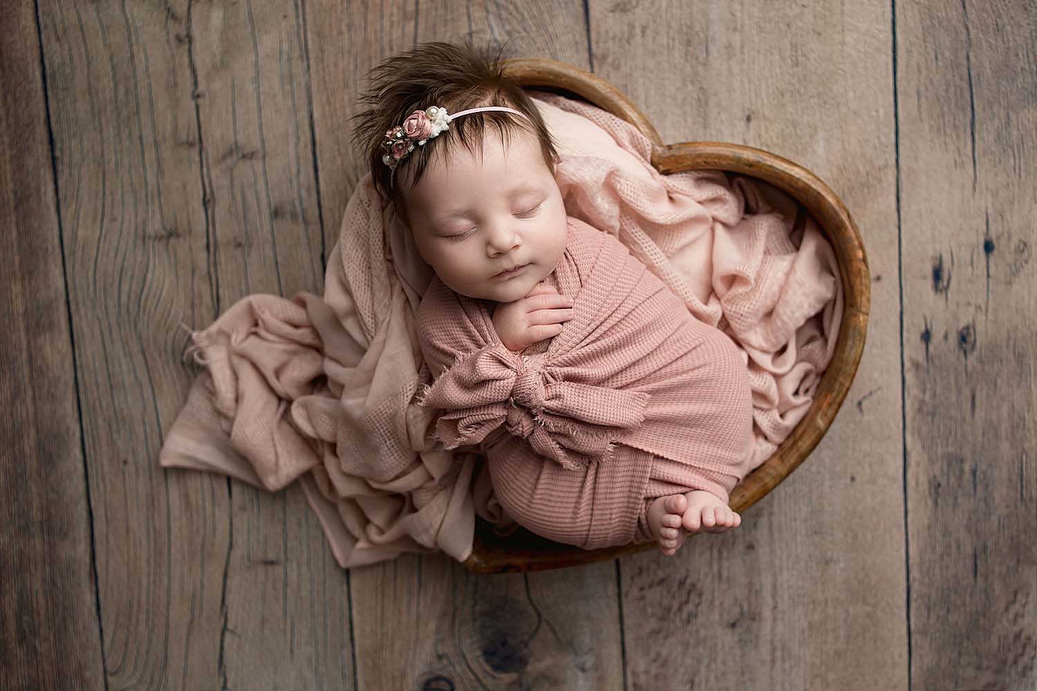 baby posed in heart for newborn photos in coral springs, fl