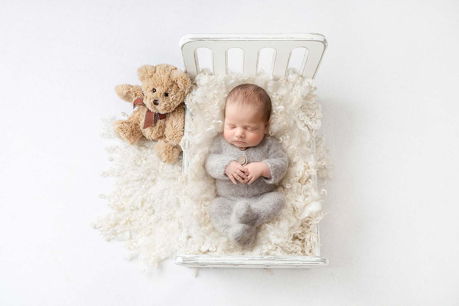 baby posed on bed for newborn session in cooper city, fl