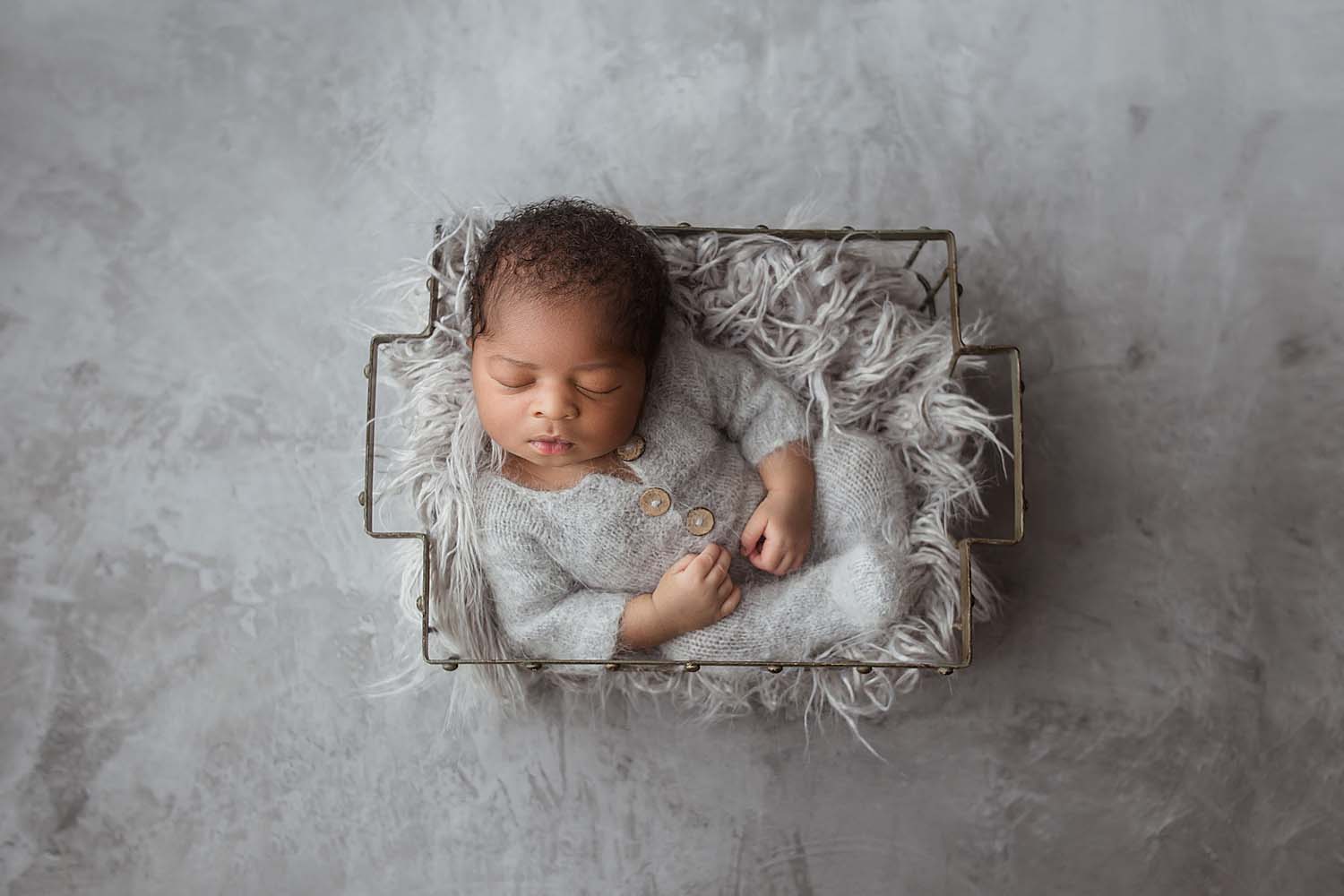 baby posed in a basket for newborn photo in davie, fl