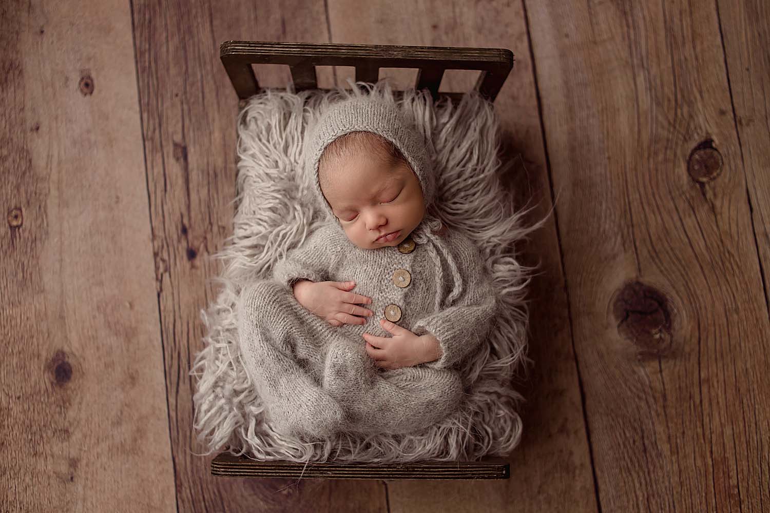 newborn baby posed in bed for photos in fort lauderdale, FL