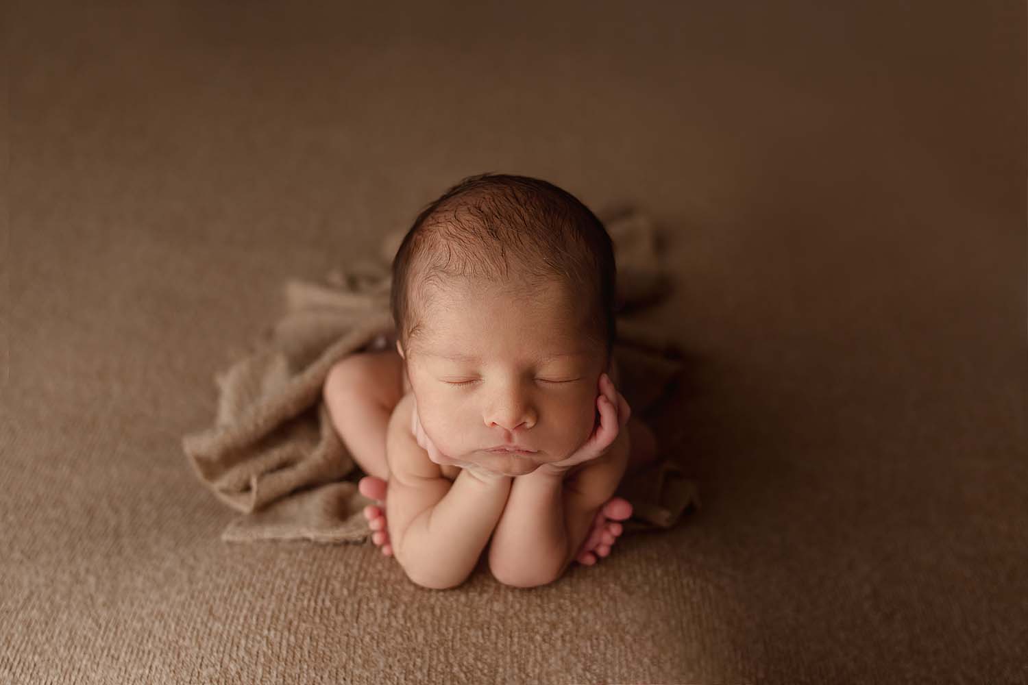 newborn baby posed in froggy pose for photos in fort lauderdale, FL