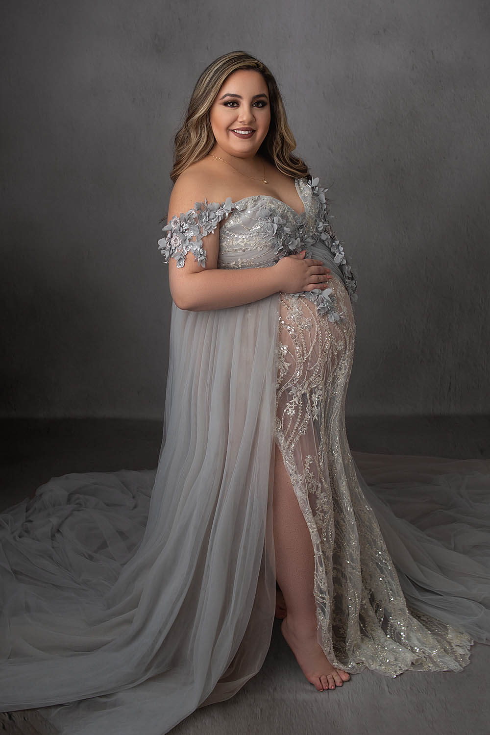 pregnant woman wearing silver gown for materinty photo fort lauderdale