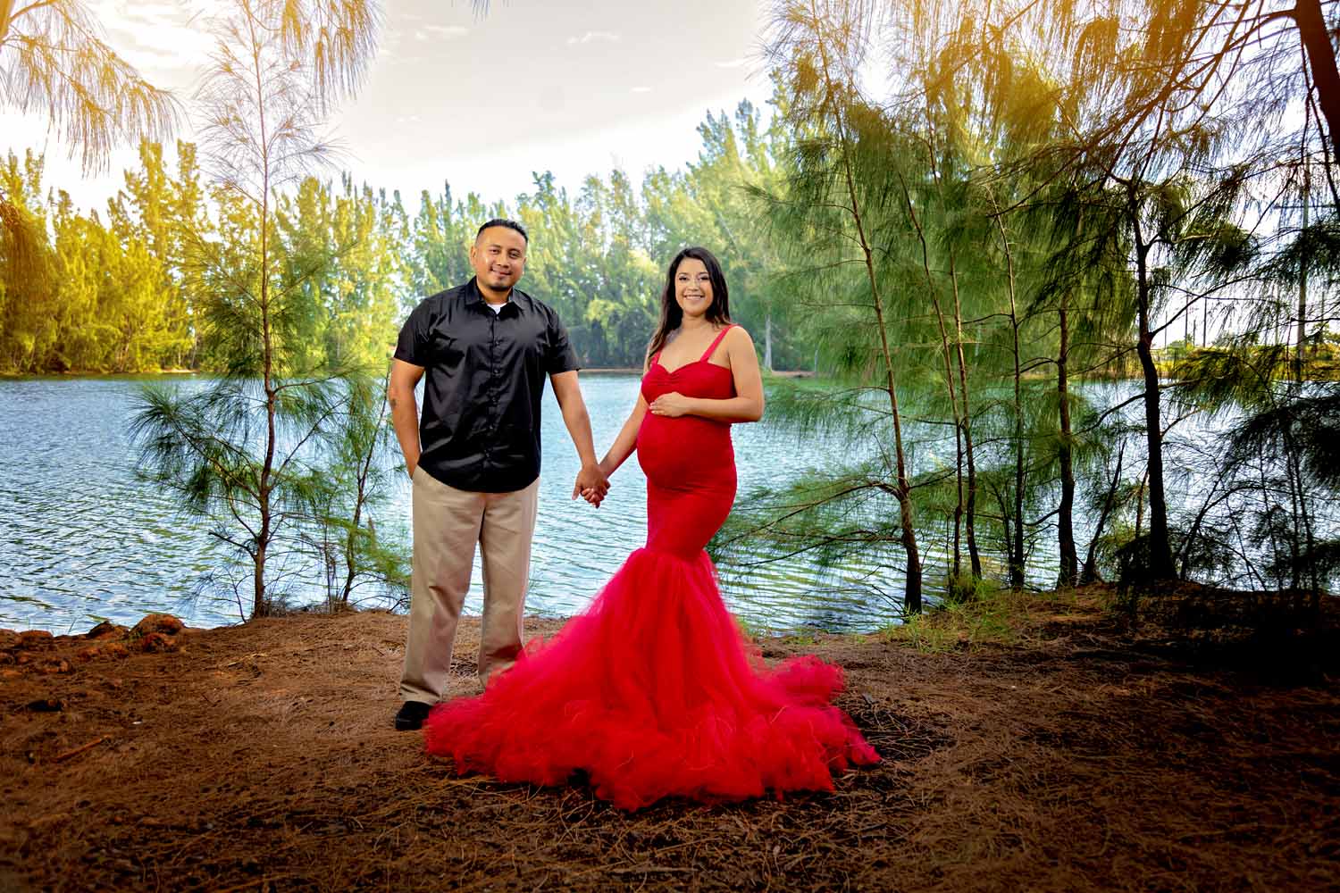 couple posed for a maternity photoshoot at wolf lake in davie fl