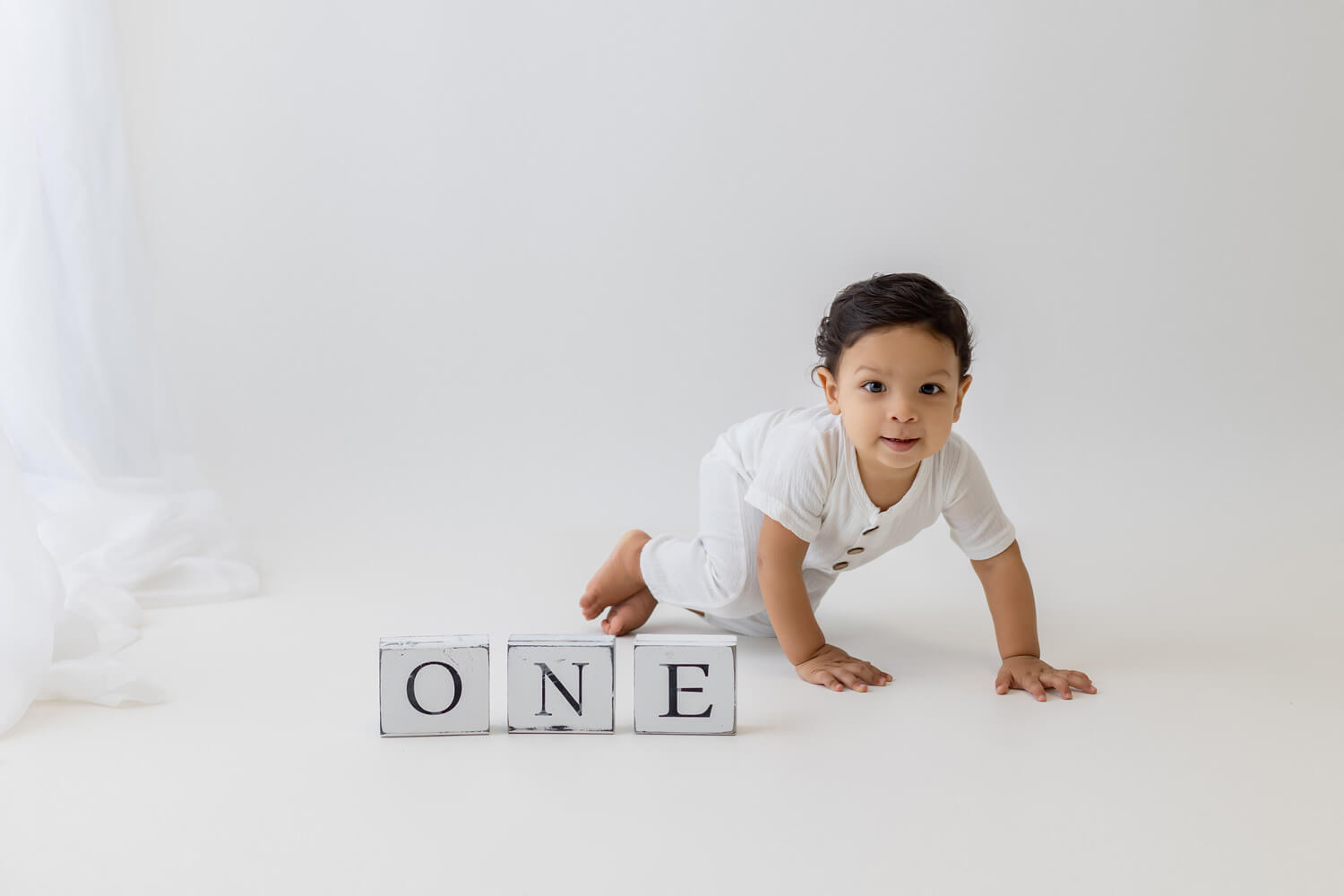 first birthday photoshoot of baby crawling